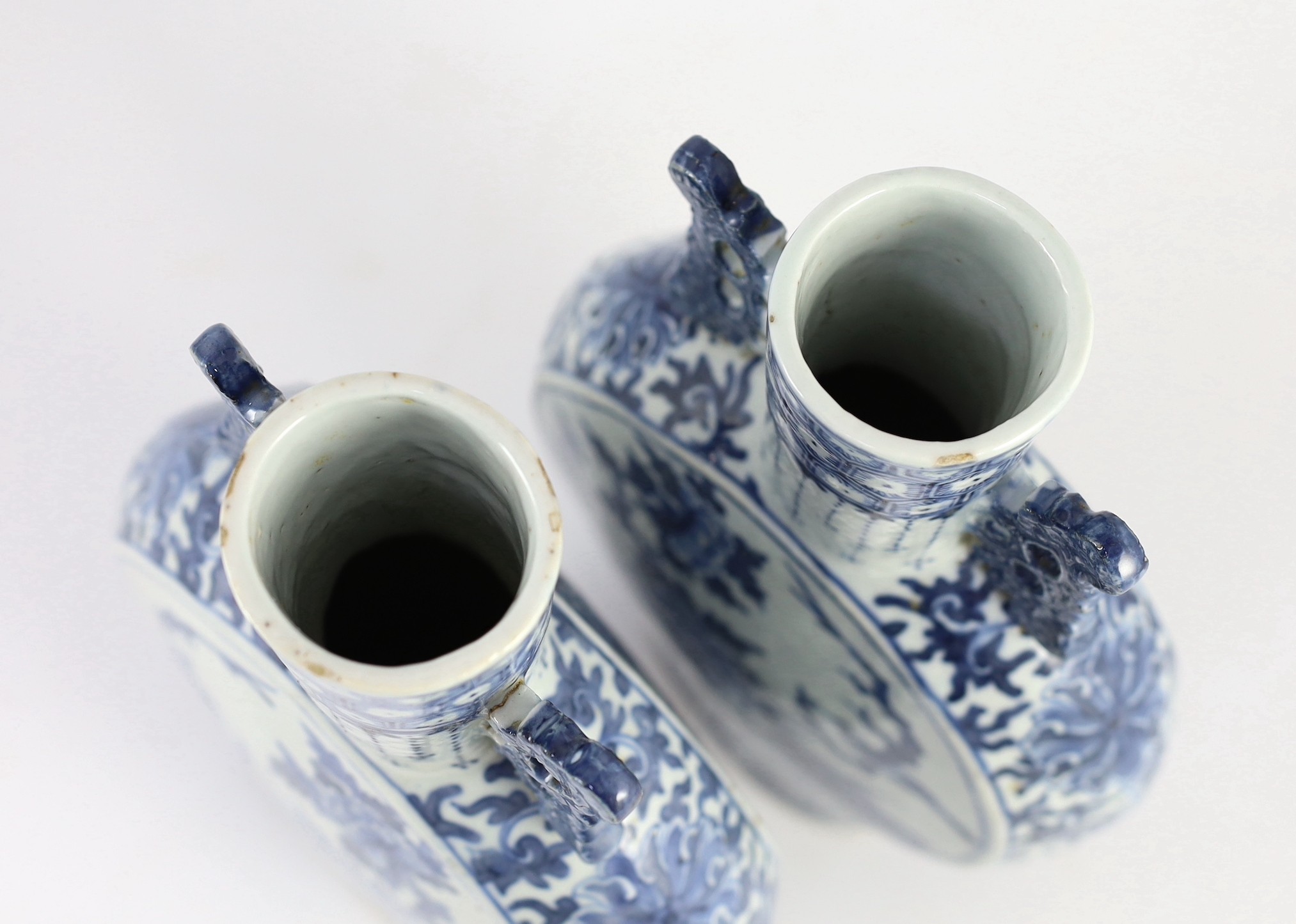 A pair of Chinese blue and white moon flasks, 19th century, 30cm high, small glaze losses and firing cracks